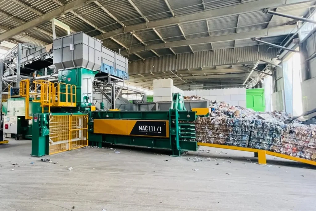 Macpresse MAC 111/1 baler processing mixed recyclable materials in a material recovery facility.