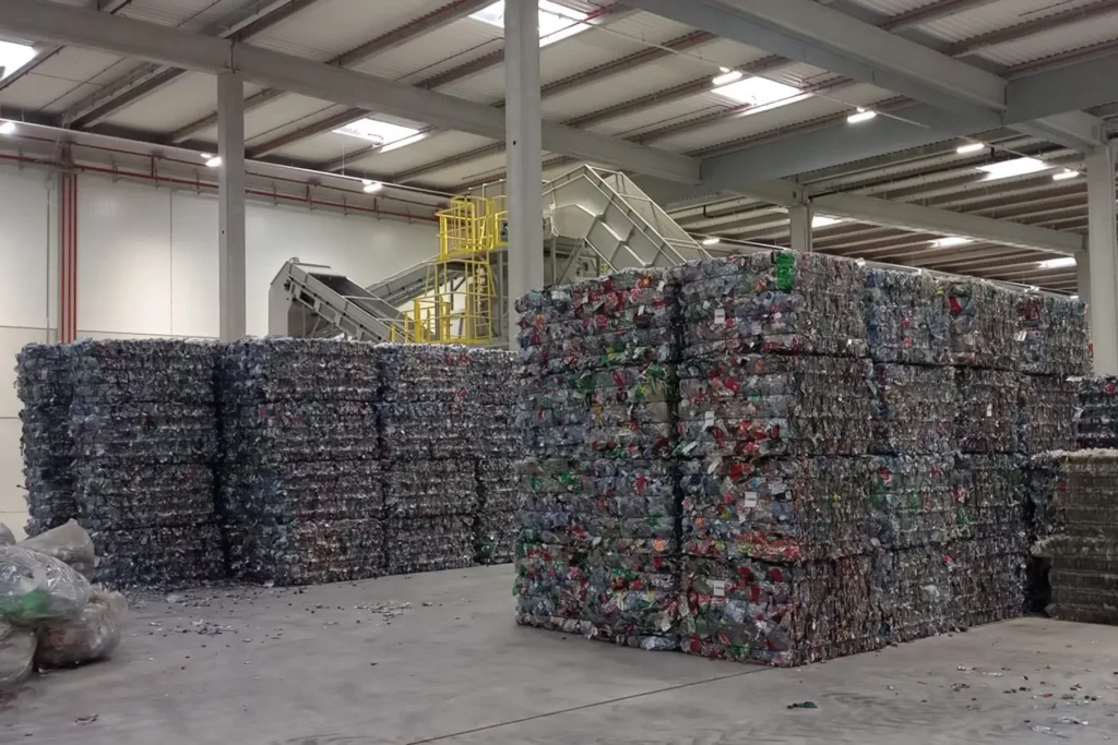 Plastic bales stored inside a material recovery facility after sorting and compaction.